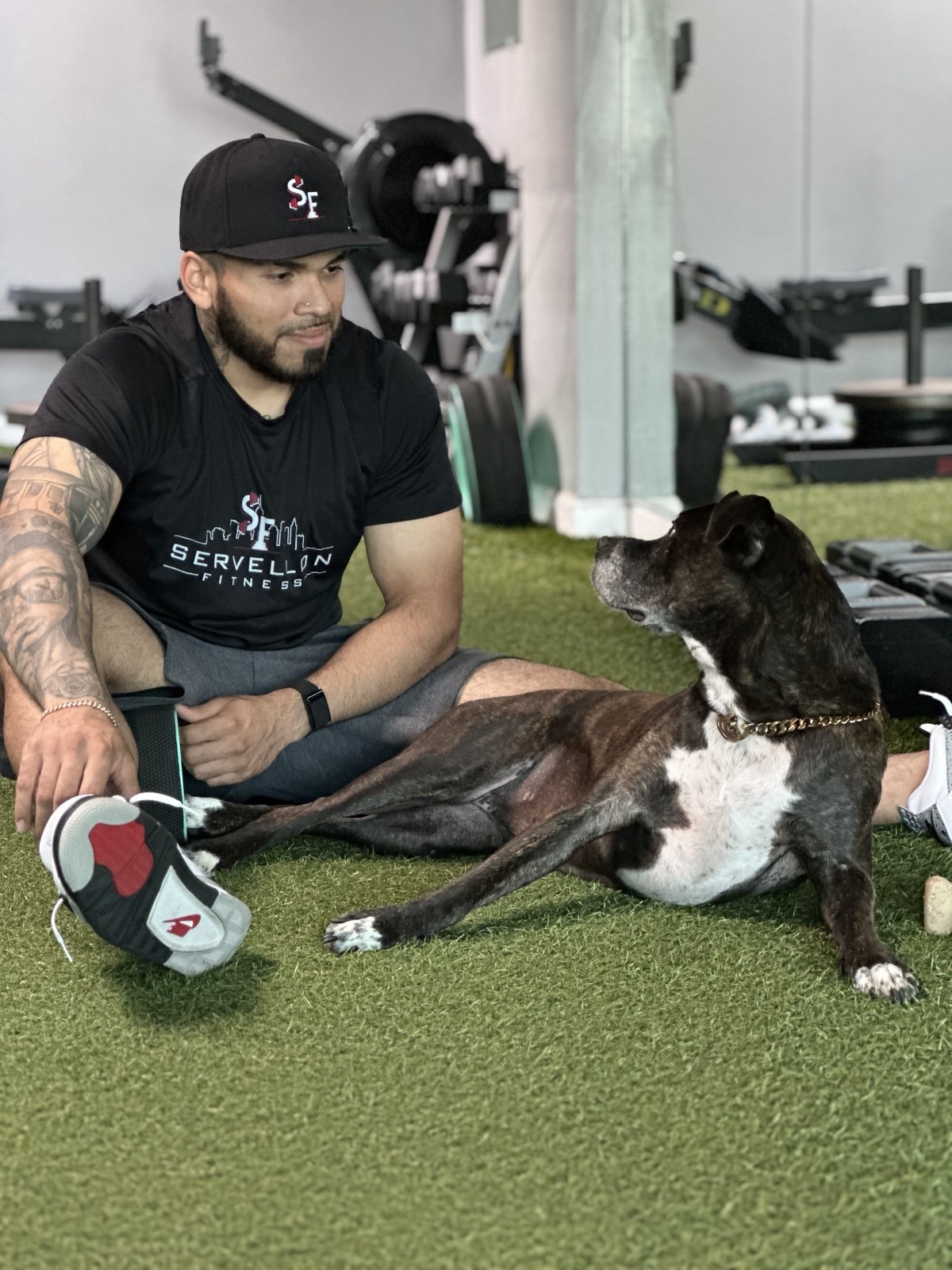 Edwin Servellon with Harley at the gym